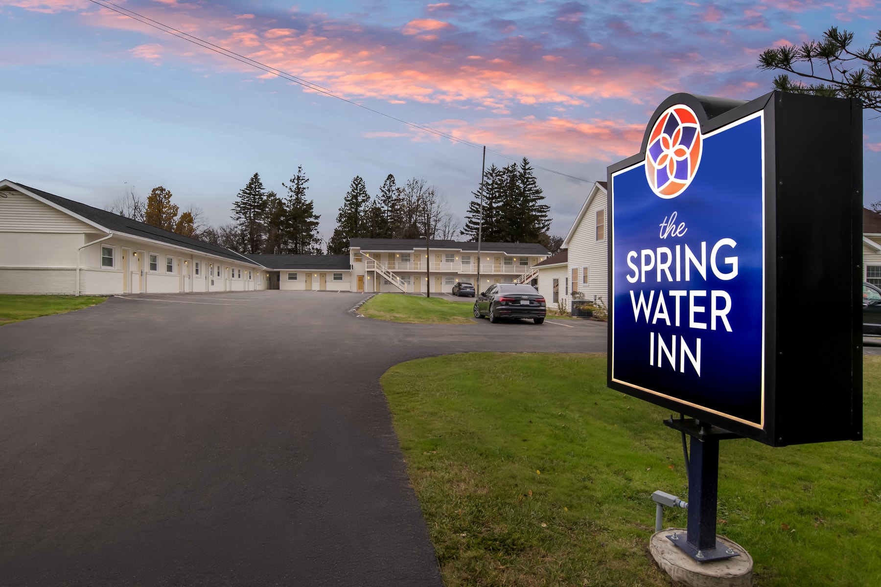 Spring Water Inn entrance sign at dusk